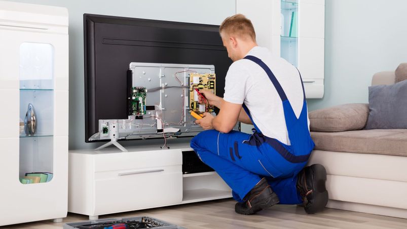 young technician checking tv